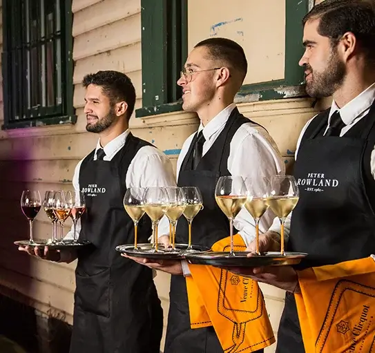 Chef plating gourmet canapés for corporate catering event in Melbourne